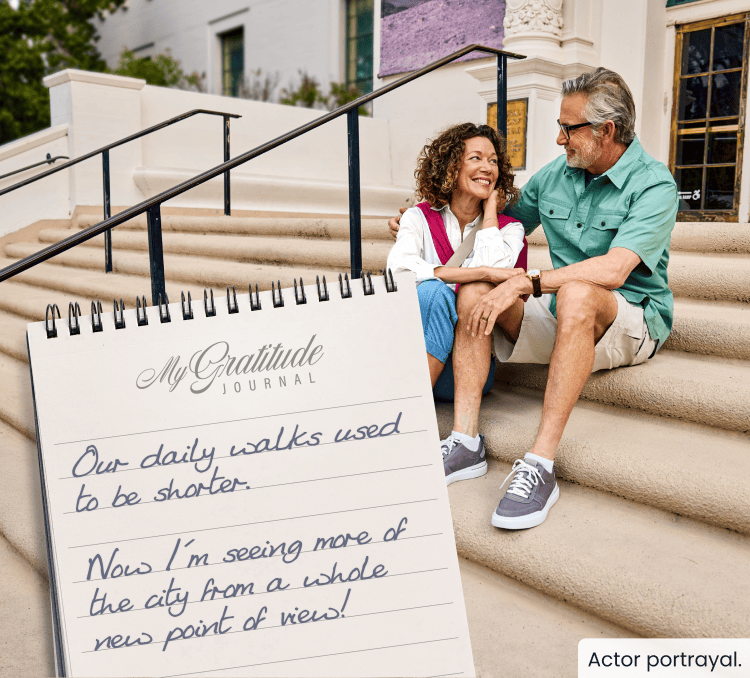 Couple sitting together on steps; My Gratitude Journal with the following entry: Our daily walks used to be shorter. Now I’m seeing more of the city from a whole new point of view!