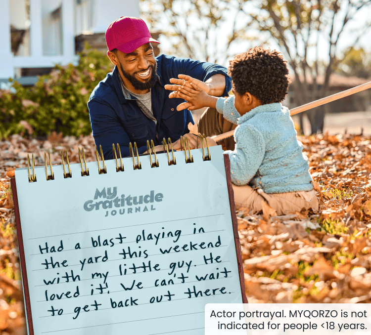 Man and young boy playing outside; My Gratitude Journal with the following entry: Being outside with my son feels great. We built a pile of leaves for him to jump in and it made his day! Looking forward to more time outside together.