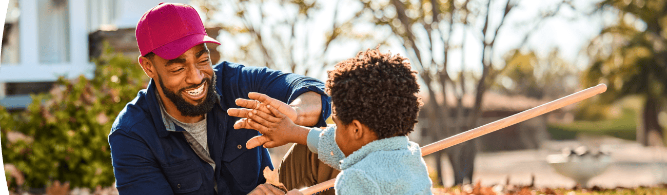 Man and young boy playing outside