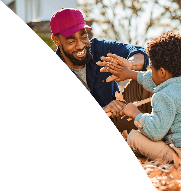 Man and young boy playing outside