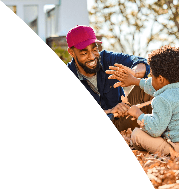 Man and young boy playing outside