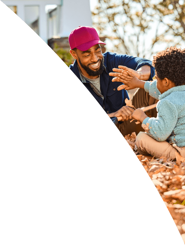 Man and young boy playing outside