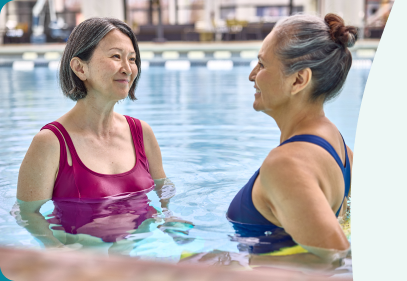 Two women talking in a swimming pool